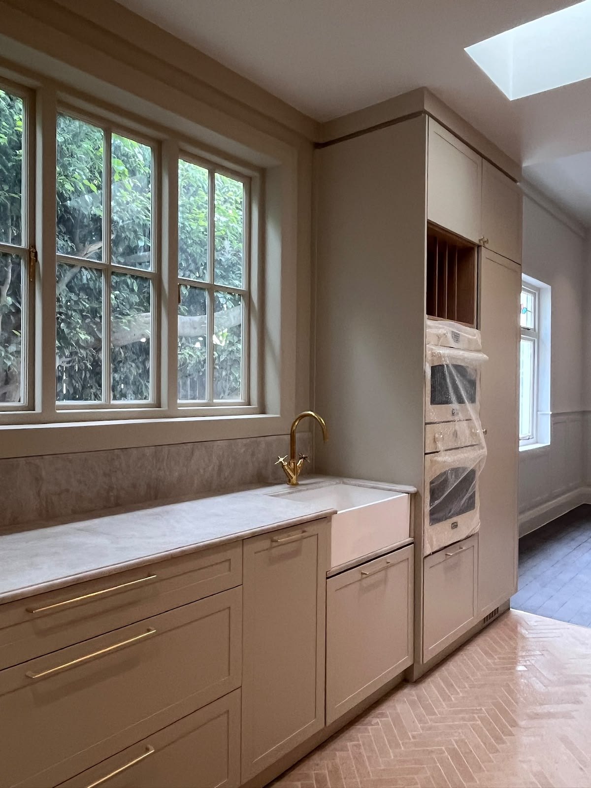Kitchen counter with wrapped ovens at Roseberry Avenue